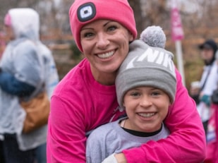 Girls on the Run participant and parent smile the at 5K celebration