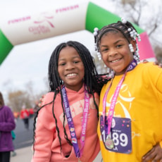 Two GOTR kids with medals smiling at the camera