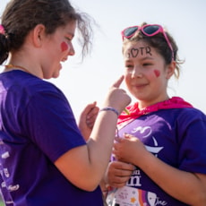 One GOTR kid putting face paint on another kid
