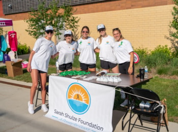 Sarah Shulze Foundation volunteers standing behind a table